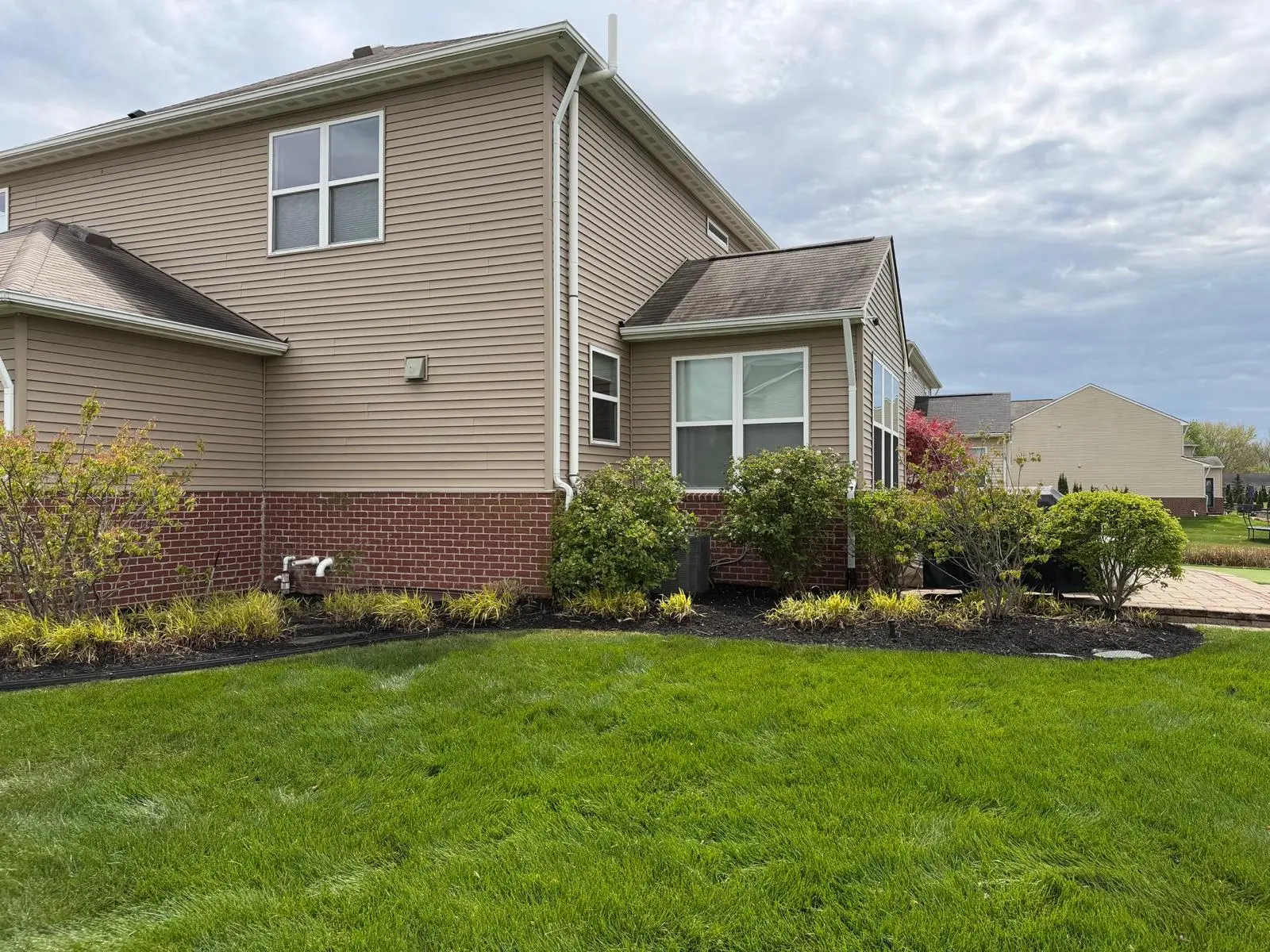Fully developed backyard putting green integrated with matured landscape design