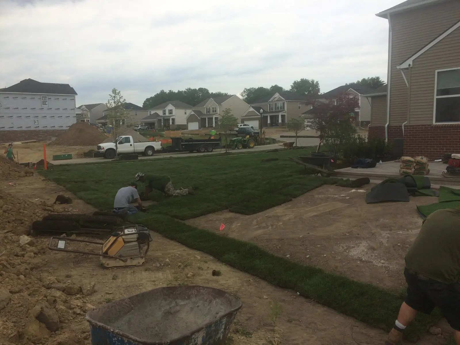 Landscape grading and soil preparation for backyard putting green installation
