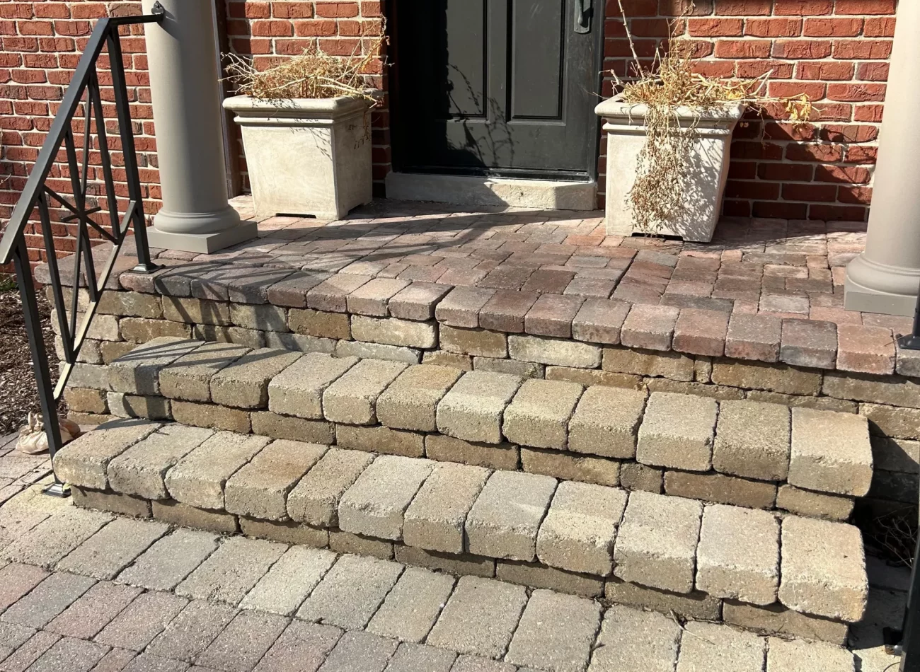Bloomfield Hills paver patio reconstruction with custom retaining wall and Unilock steps installed by Grow Garden and Landscape Design